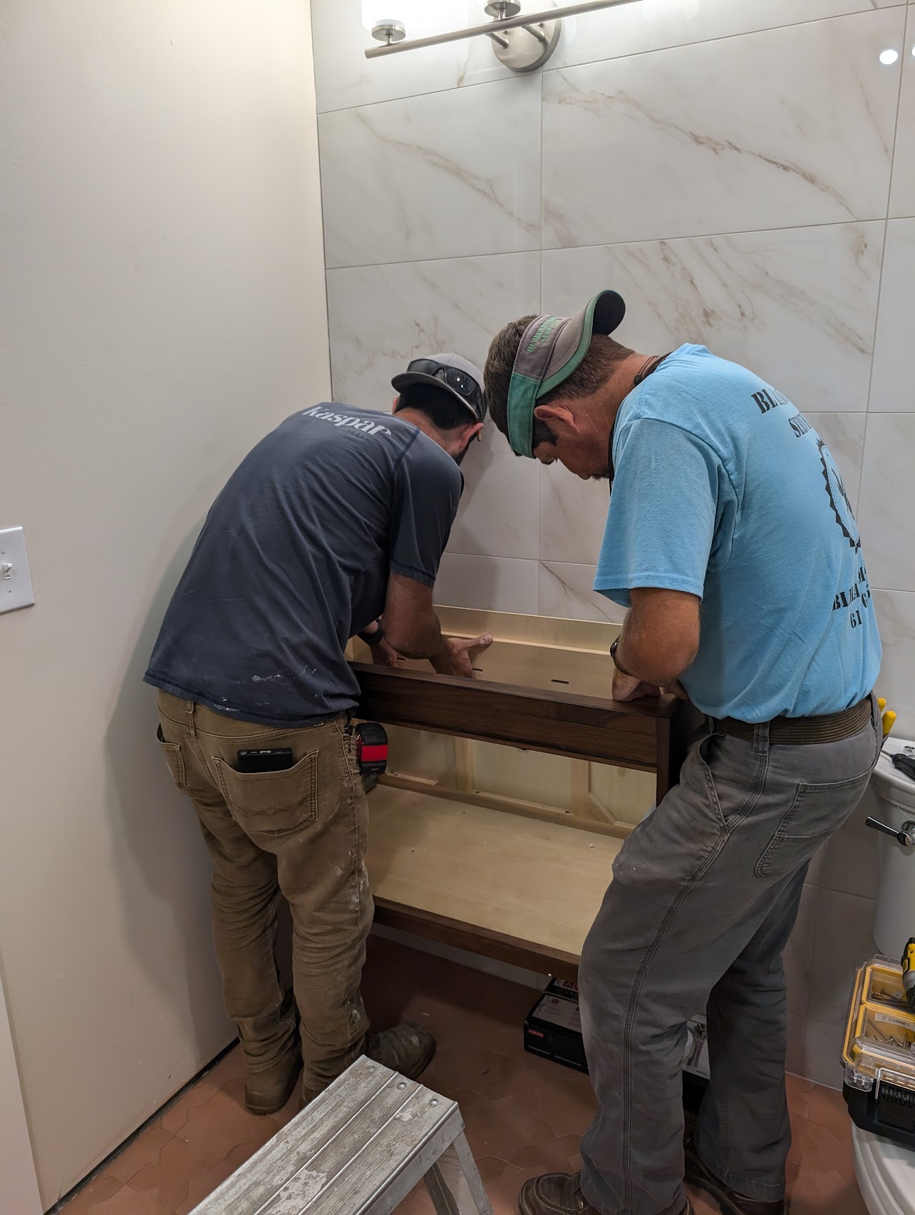 Adam Lazenby working on a bathroom remodeling project, showcasing his professional craftsmanship and attention to detail