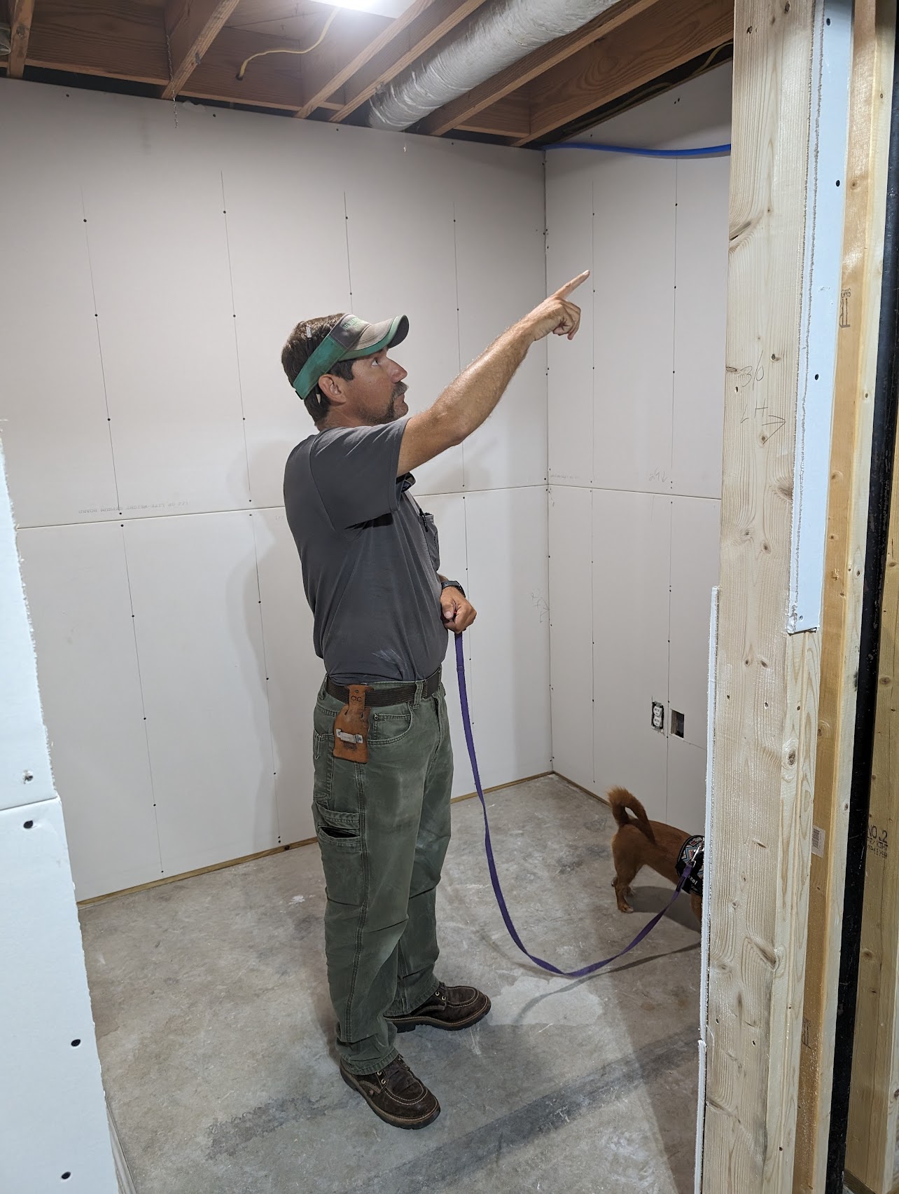 Adam Lazenby working on a home remodeling project, demonstrating his skills as a craftsman and contractor