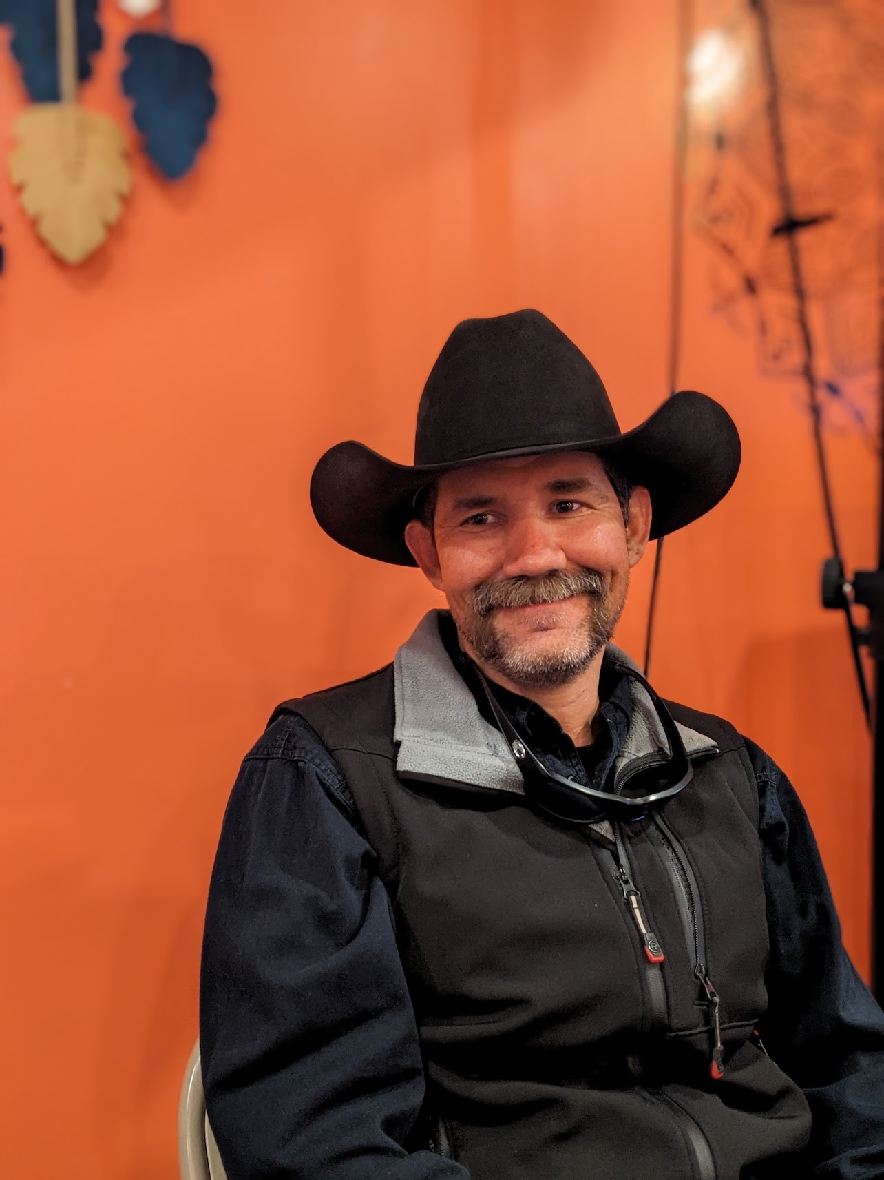 Adam Lazenby smiling warmly while wearing his cowboy hat, showing his genuine personality and southern charm